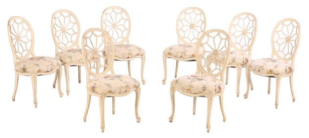 EIGHT PAINTED AND CARVED WOOD DINING CHAIRS HAVING A PINWHEEL STYLE BACK.
