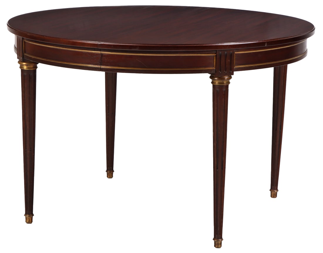 FRENCH LOUIS XVI STYLE MAOHGANY BRONZE MPOUNTED DINING TABLE C 1945 HAVING THREE LEAVES, ONE BEING: French Louis XVI style maohgany bronze mpounted dining table C 1945 having three leaves, one being skirted. Each leaf measuring a width of 19.5" fully opening to a width of 106". Ht: 29.75" Wd: 47.5" 