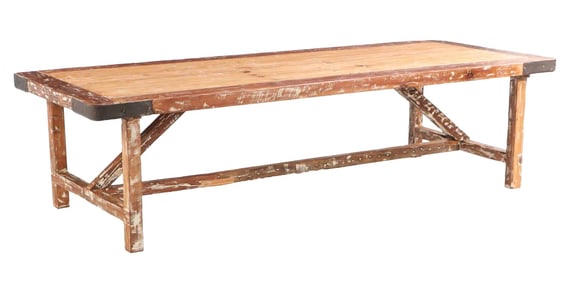 LARGE PITCH PINE RUSTIC FARM TABLE HAVING IRON WRAPPED CORNERS AND STRETCHER BASE.