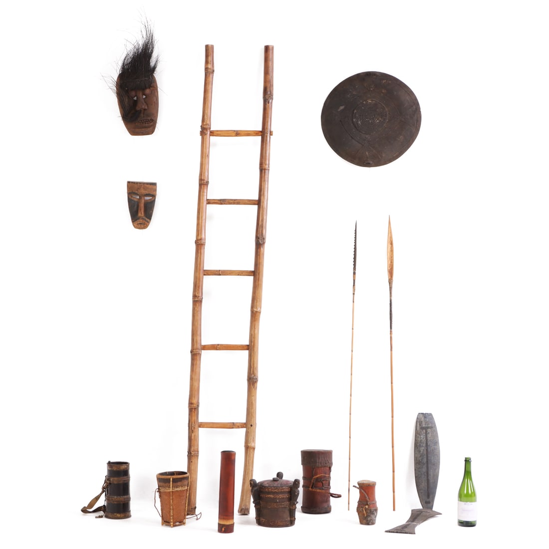 COLLECTION OF PRIMITIVES INCLUDING DRUMS, MASKS, SPEARS, BLOWGUN QUIVER WITH DARTS, MORE, BORNEO: Collection of primitives including drums, masks, spears, blowgun quiver with darts and more items sourced from Borneo in 1970. Measurements provided correspond to the largest item. Ht: 82" Wd: 12.5" D