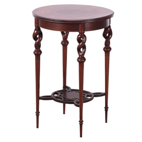 AN ART NOVEAU PEDESTAL OR SIDE TABLE HAVING TWISTED LEGS AND CIRCULAR LINE INLAID TOP