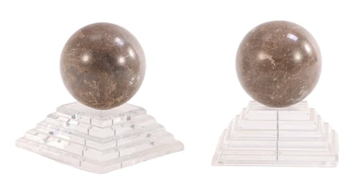 ONE OF TWO PAIR OF POLISHED MARBLE SPHERES MOUNTED ON LUCITE BASES.