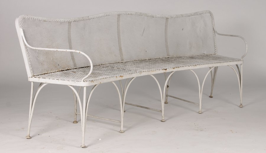 STYLISH CURVED WROUGHT IRON GARDEN BENCH C. 1930: Stylish curved wrought iron garden bench having serpentine back with chainmail style screen and arched base circa 1930. Ht: 31.5" Width: 78.5" Depth: 18"