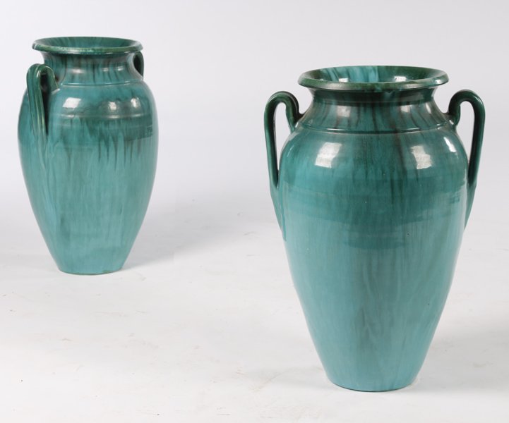 PAIR 2 HANDLED GLAZED EARTHENWARE VESSELS: A good pair of two handled glazed earthenware vessels, each having mottled green glaze circa 1930. Ht: 22" Width: 14.5"