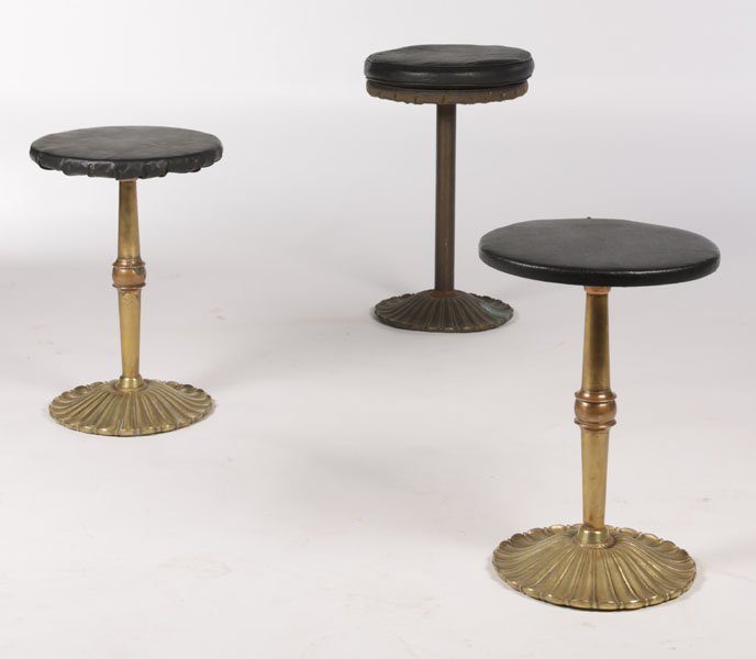 ASSOCIATED SET 3 BRONZE STOOLS UPHOLSTERED: A stylish associated set of three bronze stools having upholstered tops supported on tapered and banded shaft with sunburst base circa 1950. Ht: 18" Dia: 12"