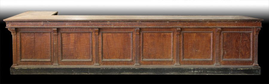 L SHAPED STORE COUNTER TOP CIRCA 1880: A late nineteenth Century store counter having L shaped scrubbed top over faux wood painted paneled front with fluted column decoration circa 1880. Ht: 33" Width: 144" Depth: 51.5"
