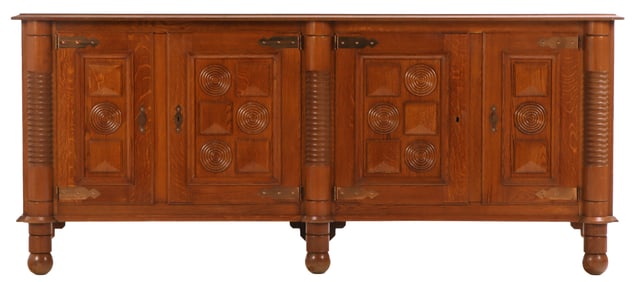 FOUR DOOR FRENCH OAK SIDEBOARD WITH GEOMETRIC MOTIFS IN THE MANNER OF CHARLES DUDOUYT C 1940.