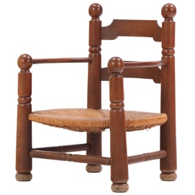 OAK AND RUSH ARM CHAIR WITH BALL FORM FINIALS BY CHARLES DUDOUYT C 1945.