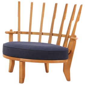 GUILLERME AND CHAMBRON TRICOTEUSE OAK LOUNGE CHAIR HAVING BLUE UPHOLSTERY CIRCA 1960.