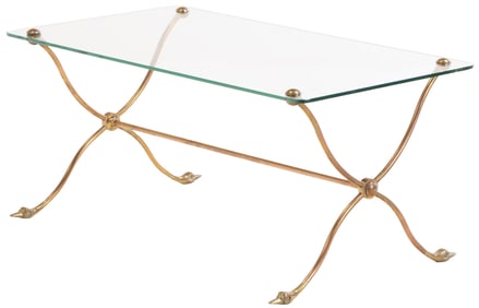FRENCH BRASS AND GLASS COFFEE TABLE HAVING A SHAPED BASE WITH DUCK HEAD FEET.