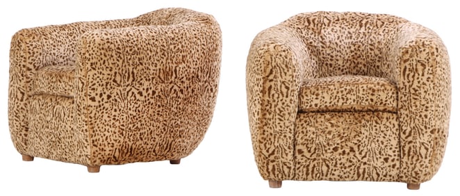 PAIR SHAPED LOUNGE CHAIRS UPHOLSTERED IN FAUX LEOPARD.