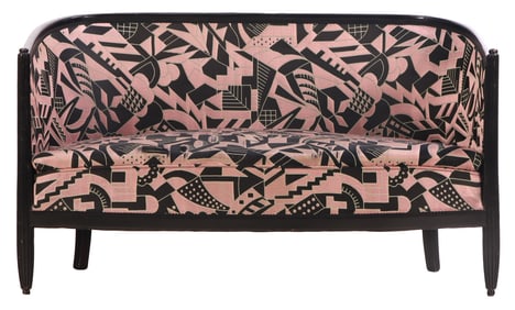 FRENCH ART DECO SETTEE HAVING AN EBONIZED FRAME AND APPROPRIATE FABRIC.