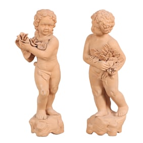 A PAIR OF TERRACOTTA FIGURES OF YOUNG GIRLS HOLDING FLOWERS.
