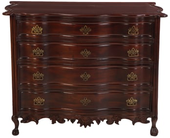 NINETEENTH CENTURY PORTUGUESE COMMODE HAVING A CARVED SKIRT AND BALL AND CLAW FEET.