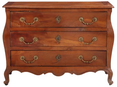 EIGHTEENTH CENTURY FRENCH CHERRY BOMBAY FORM COMMODE HAVING THREE DRAWERS.