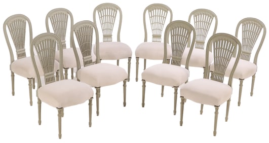 TEN PAINTED AND CARVED DINING CHAIRS IN THE MANNER OF JANSEN HAVING UPHOLSTERED SEATS WITH NEW