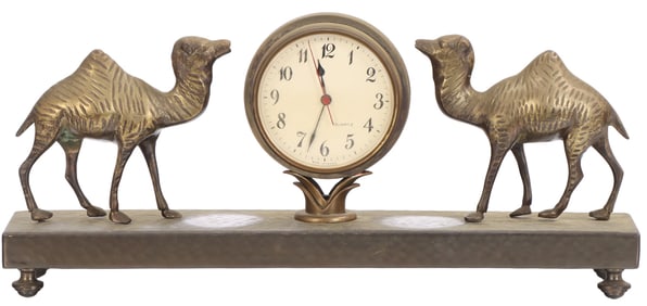 A VINTAGE FRENCH METAL CLOCK WITH OPPOSING CAMELS.
