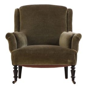 NINETEENTH CENTURY UPHOLSTERED LIBRARY CHAIR HAVING EBONIZED TURNED FEET