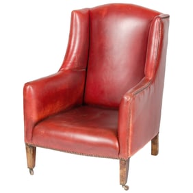 AN ENGLISH RED LEATHER CLUB WINGBACK ARMCHAIR CIRCA 1960.