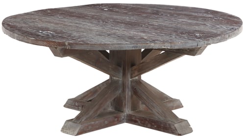 A LARGE BLACK CERUSED OAK TABLE HAVING A CIRCULAR TOP RESTING ON AN X FORM PEDESTAL BASE.