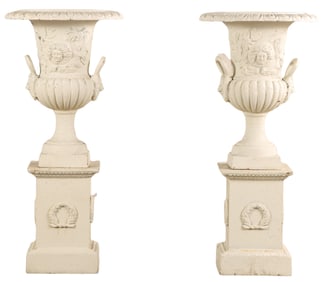 48" PAIR OF PAINTED CAST IRON GARDEN URNS WITH HANDLES ON DECORATED PEDESTALS.