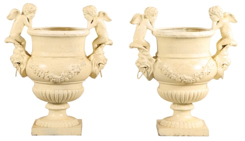 38" PAIR OF PAINTED CAST IRON GARDEN URNS HAVING CUPID HANDLES AND FLORAL SWAGS.