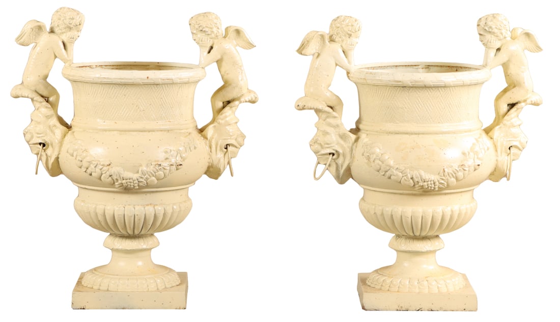 38" PAIR OF PAINTED CAST IRON GARDEN URNS HAVING CUPID HANDLES AND FLORAL SWAGS.: 38" pair of painted cast iron garden urns having Cupid handles and floral swags. Ht: 37.5" Wd: 31.25" Dpth: 18.5"