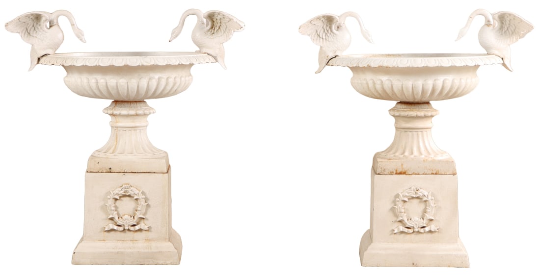 42" PAIR OF PAINTED CAST IRON VICORIAN STYLE GARDEN URNS WITH ELEGANT SWAN HANDLES RESTING ON A: 42" Pair of painted cast iron Vicorian style garden urns with elegant swan handles resting on a seperate base with applied wreath.. Ht: 42" Wd: 39" Dpth: 29.5"