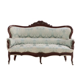 VICTORIAN CARVED SOFA HAVING A CENTRAL CARVED CREST AND EXCELLENT SILK UPHOLSTERY C 1870.