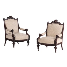 PAIR OF CARVED OPEN ARM CHAIRS WITH RAMS HEAD TERMINALS AND MUSICAL INSTRUMENTS IN THE CRESTS