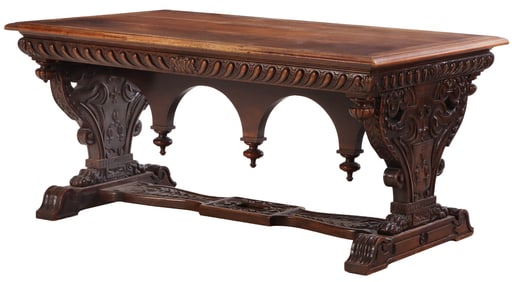 CARVED WALNUT LIBRARY TABLE IN THE RENAISSANCE STYLE HAVING PAW FEET AND A CARVED STRETCHER C
