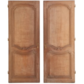 A PAIR OF ANTIQUE CARVED OAK FRENCH DOORS.