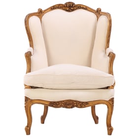A LOUIS XV STYLE GILT CARVED BERGERE CHAIR HAVING BEEN RECENTLY REUPHOLSTERED C 1890.