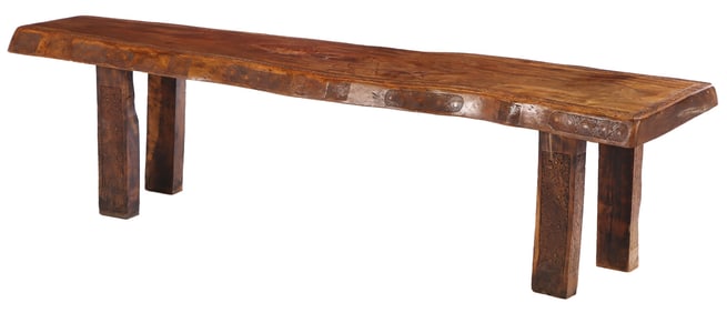 A SUBSTANTIAL BRAZILIAN MAHOGANY SLAB TOP TABLE HAVING A SHAPED EDGE AND A FOUR INCH THICK TOP C