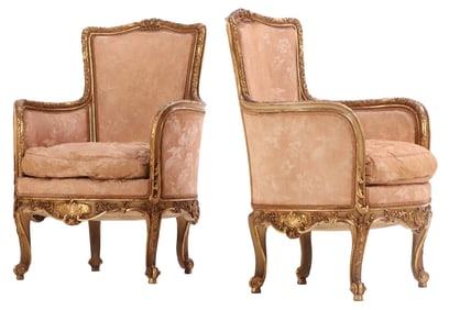 PAIR OF FRENCH CARVED AND GILTWOOD BERGERE CHAIRS IN THE LOUIS XV STYLE HAVING A SHELL CARVED SKIRT