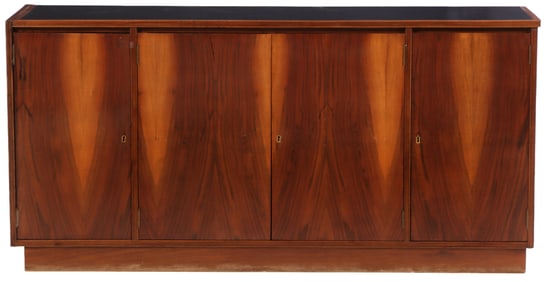 FOUR DOOR ROSEWOOD SIDEBOARD WITH INTERIOR DRAWERS AND AN INSET BLACK LAMINATE TOP C 1965.