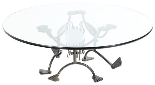 IRON AND GLASS TOP COFFEE TABLE WITH ABSTRACT HUMAN FIGURES.