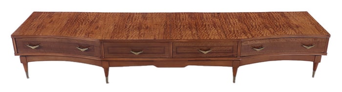 A MID CENTURY MODERN FOUR DRAWER MOZAMBIQUE LOW DRESSER HAVING BRASS TRIM.