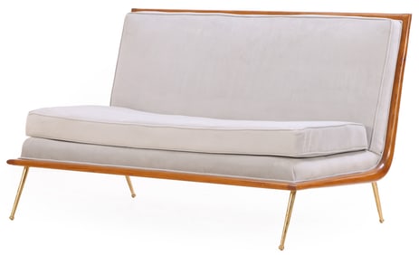 MAHOGANY UPHOLSTERED SOFA RESTING ON BRASS LEGS IN THE MANNER OF ROBSJOHN-GIBBINGS.