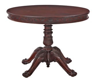 A DANIEL PABST ATTRIBUTED CIRCULAR WALNUT OCCASIONAL TABLE HAVING INCISED APRON AND