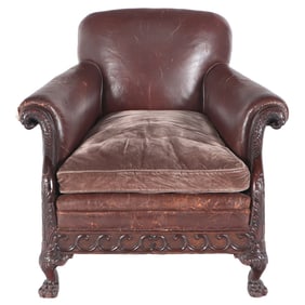 CARVED ENGLISH MAHOGANY AND LEATHER CLUB CHAIR HAVING BIRD HEAD TERMINALS AND CLAW FEET C 1910.