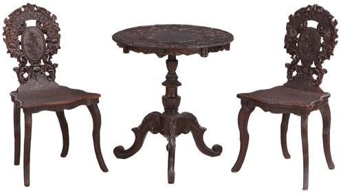 A PAIR OF CARVED MAHOGANY BLACK FOREST SIDE CHAIRS WITH MATCHING OCCASIONAL TABLE C 1890.