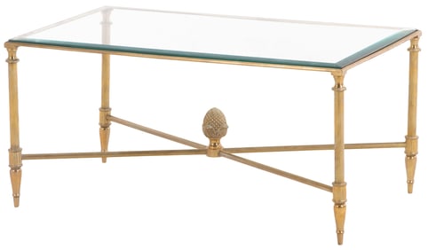 A BRASS AND GLASS COFFEE TABLE HAVING AN X STRETCHER BASE SUPPORTING A LARGE ACORN FINIAL AND