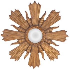 A CARVED IN GILTWOOD SUNBURST MIRROR HAVING A CENTRAL ROUND MIRROR CIRCA 1960