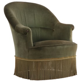ONE OF FOUR NAPOLEON III STYLE UPHOLSTERED LOUNGE CHAIR WITH FRINGE DECORATION.