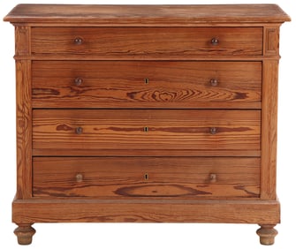 A CONTINENTAL LATE 19TH CENTURY FOUR DRAWER PITCH PINE DRESSER RESTING ON TURNED FEET.