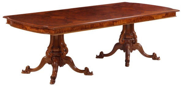 AN ITALIAN BURLED WALNUT DOUBLE PEDESTAL DINING ROOM TABLE HAVING BOOKMATCHED VENEER AND REGENCY