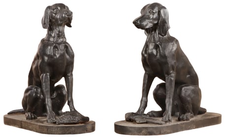 A PAIR OF PAINTED CAST IRON SEATED HOUNDS HAVING PREY AT THEIR FEET.