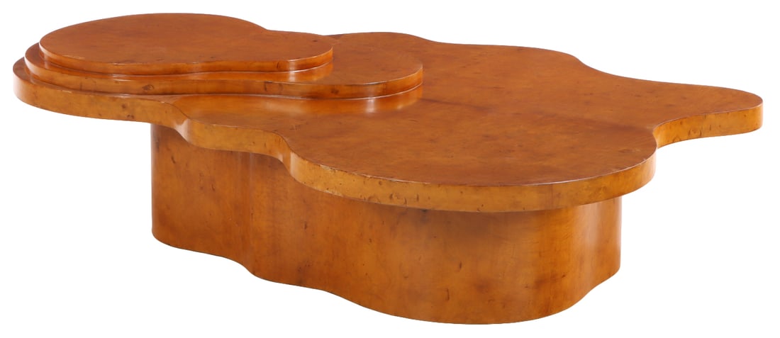 A SHAPED BIOMORPHIC BIRDSEYE MAPLE COFFEE TABLE IN THE MANNER OF T.H. ROBSJOHN-GIBBINGS.: A shaped biomorphic birdseye maple coffee table in the manner of T.H. Robsjohn-Gibbings. Ht: 18" Wd: 70" Dpth: 51"