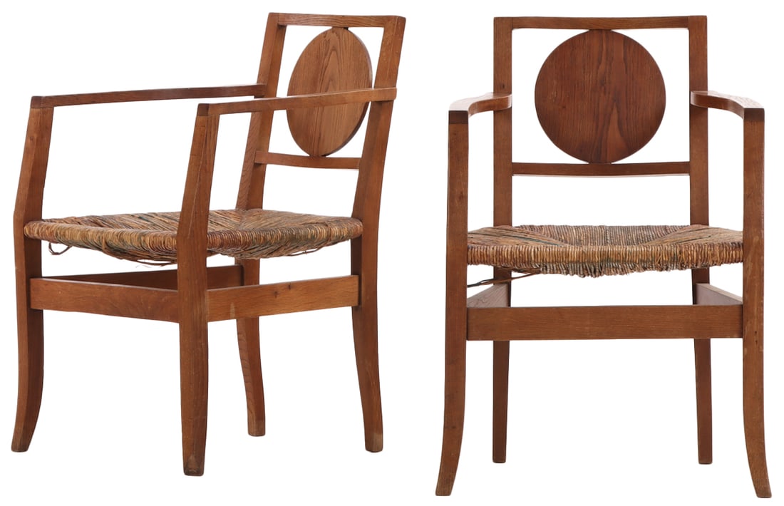 A PAIR OF FRENCH OAK OPEN ARM CHAIRS HAVING CIRCULAR BACK SPLATS AND RUSH SEATS CIRCA 1940. (1 of 6)